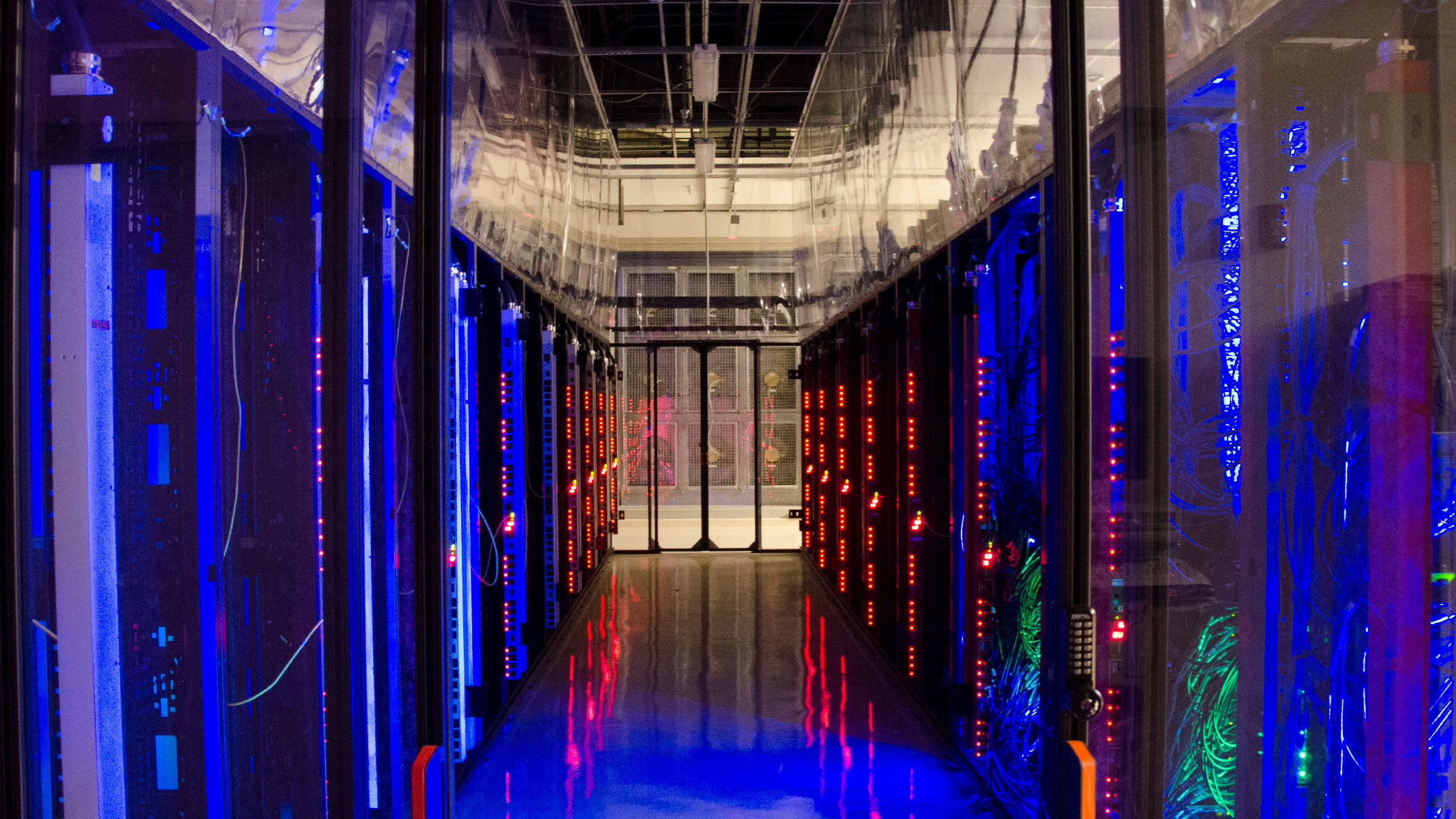 Two server racks face each other across a hallway