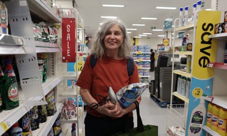 A woman stands in the aisle of a store.