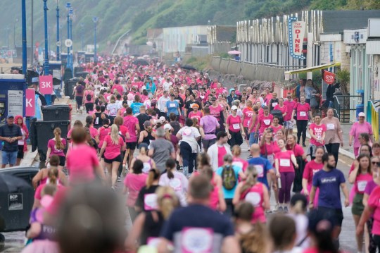 Fundraisers take part in a rainy Race For Life 5k run, organised by Cancer Research UK, along the seafront at Boscombe beach in Dorset. The Met Office has issued guidance that most of the UK will meet heatwave criteria next week, and an amber alert for hot weather for hot weather has been issued by the UK Health Security Agency (UKHSA). Picture date: Sunday June 11, 2023. PA Photo. Photo credit should read: Andrew Matthews/PA Wire