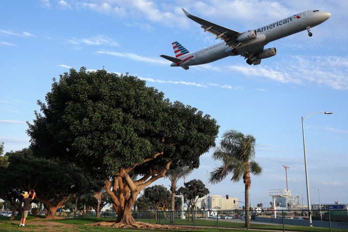 An American Airlines plane landing from a park next to Los Angeles International Airport (LAX) in August