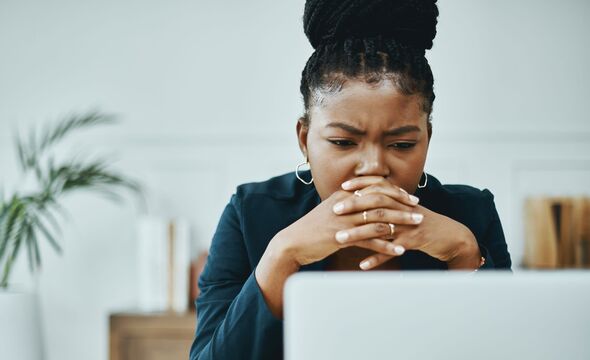 Woman confused while looking at laptop