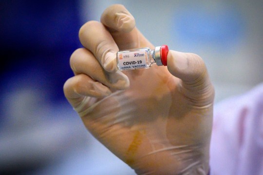 This picture taken on May 23, 2020 shows a laboratory technician holding a dose of a COVID-19 novel coronavirus vaccine candidate ready for trial on monkeys at the National Primate Research Center of Thailand at Chulalongkorn University in Saraburi. After conclusive results on mice, Thai scientists from the centre have begun testing a COVID-19 novel coronavirus vaccine candidate on monkeys, the phase before human trials. (Photo by Mladen ANTONOV / AFP) (Photo by MLADEN ANTONOV/AFP via Getty Images)