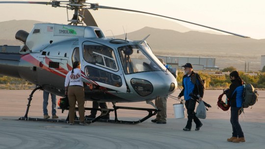 As the Sun rises recovery team members prepare to board helicopters before flying into the Utah desert to participate in the Osiris-Rex asteroid sample return and recovery mission at Dugway, Utah, on September 24, 2023. A seven-year space voyage comes to its climactic end Sunday when a NASA capsule lands in the desert in the US state of Utah, carrying to Earth the largest asteroid samples ever collected. Scientists hope the asteroid sample aboard the spacecraft will provide humanity with a better understanding on the formation of our solar system and how Earth became habitable. (Photo by GEORGE FREY / AFP) (Photo by GEORGE FREY/AFP via Getty Images)