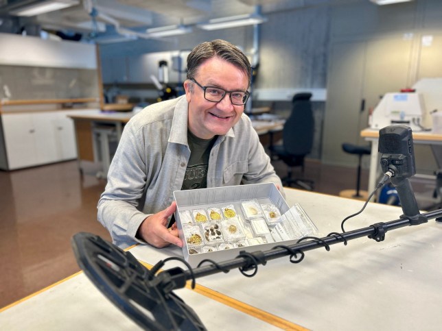 Handout photo released on September 7, 2023 by the Museum of Archaeology and the University of Stavanger (UiS), south-western Norway, shows amateur archaeologist Erlend Bore posing with a gold treasure photographed shortly after he found them in the ground with a metal detector on the island of Rennes??y in Stavanger. The treasure consists of nine gold medallions and pearls that once formed a luxurious necklace, as well as three gold rings, the University of Stavanger announced on September 7, 2023. It was discovered at the end of August on a farmer's property near Stavanger by an amateur archaeologist, Erlend Bore, who had bought a metal detector after his doctor and physiotherapist advised him to be more physically active. (Photo by Anniken Celine Berger / various sources / AFP) / Norway OUT (Photo by ANNIKEN CELINE BERGER/NTB/Arkeologisk museum, UiS /AFP via Getty Images)