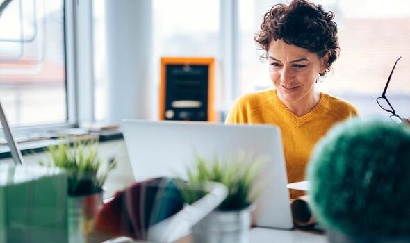 Woman smiling at laptop