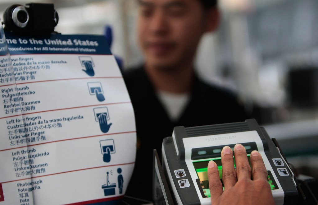 a person submitting their fingerprints at the U.S. border at New Airport in New Jersey