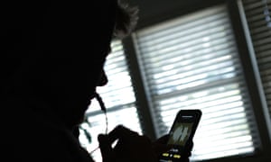 A person using a phone to record a voice message