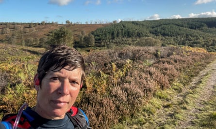 A selfie of Deb Kelly in a sporty-looking top standing in open countryside