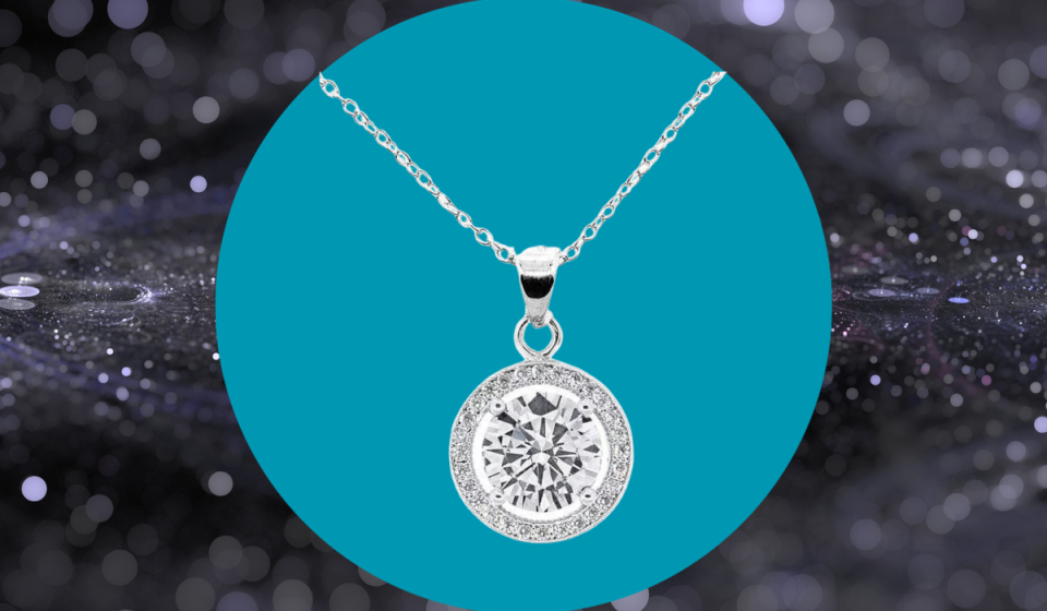 White gold and cubic zirconia necklace with round pendant.