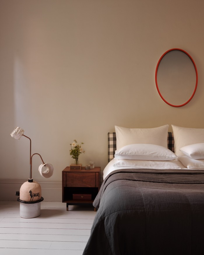 Artwork by Christopher Page on the wall of the bedroom, with a lamp by Tyler Hays, Loro Piana treasure box (on bedside table) and a bed by Hästens