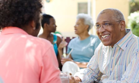 People sitting outdoors, talking and smiling