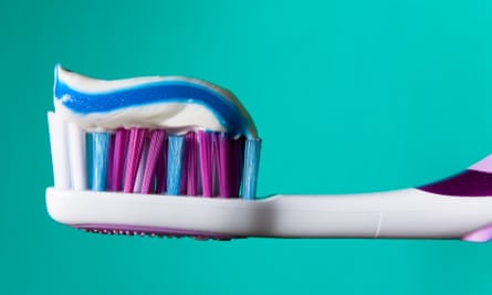 Multicoloured toothbrush and toothpaste.