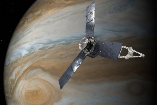 An artist's impression of Nasa's Juno spacecraft in orbit above Jupiter