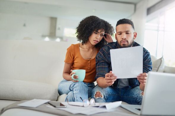 Couple looking concerned at letter