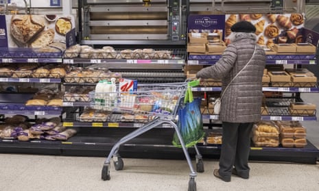 Shoppers buy products in Asda supermarket in London as UK inflation rises to 10.1% due to rising food prices.