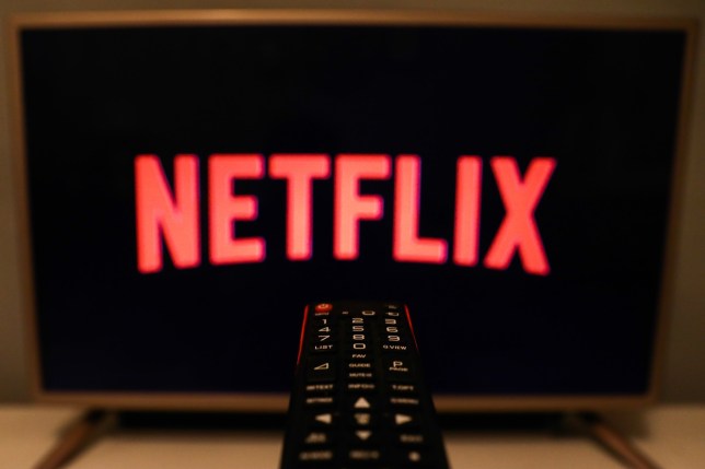 Netflix logo is seen displayed on TV screen