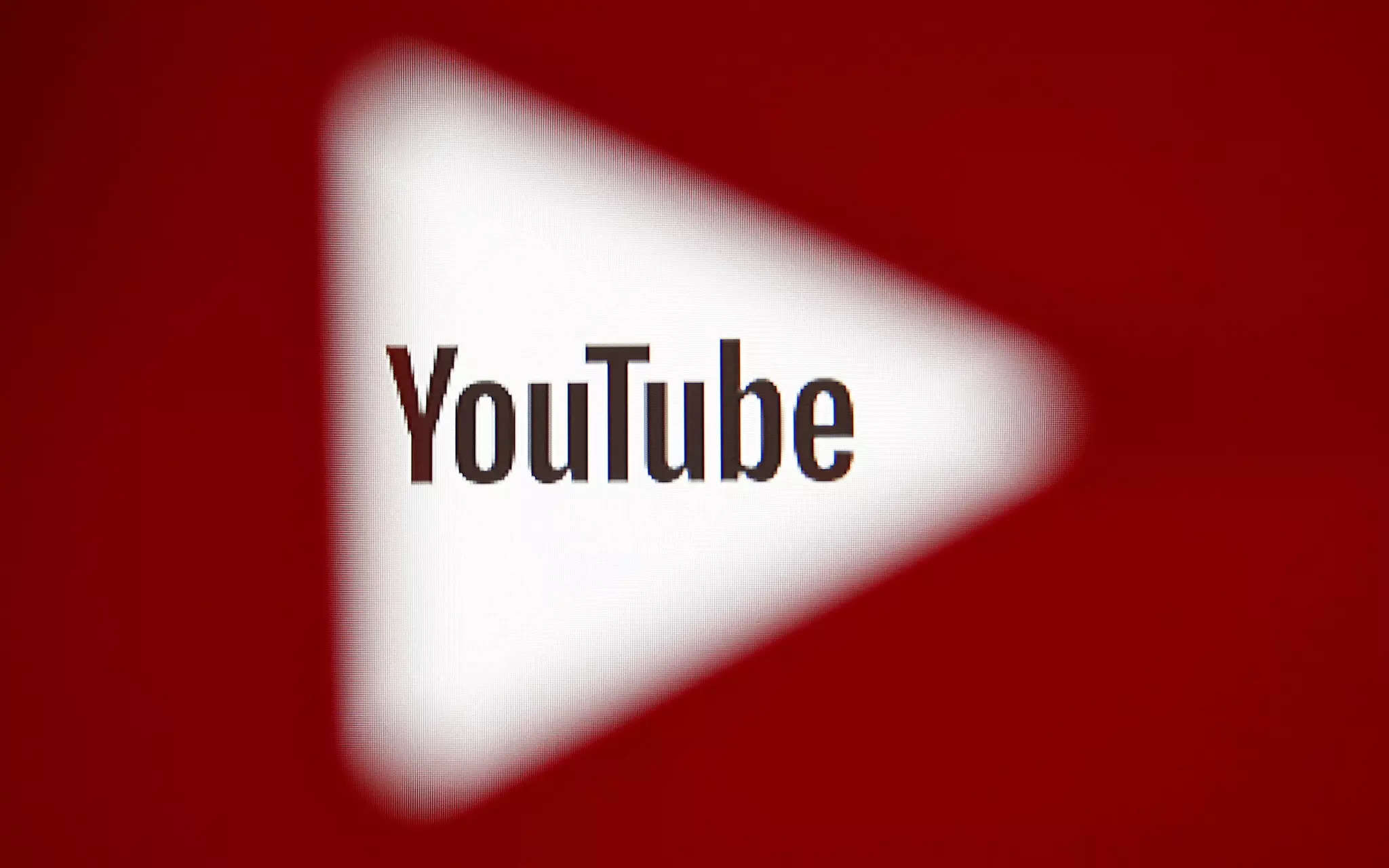 FILE PHOTO: A 3D-printed YouTube icon is seen in front of a displayed YouTube logo in this illustration