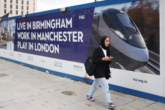 An HS2 advert in Birmingham reading “Live in Birmingham, work in Manchester, play in London”