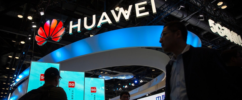 FILE - Attendees walk past a display for 5G services from Chinese technology firm Huawei at the PT Expo in Beijing, on Oct. 31, 2019. Taiwan authorities are investigating four Taiwan-based companies suspected of helping China’s Huawei Technologies to build semiconductor facilities, reports said Friday, Oct. 6, 2023. (AP Photo/Mark Schiefelbein, File)