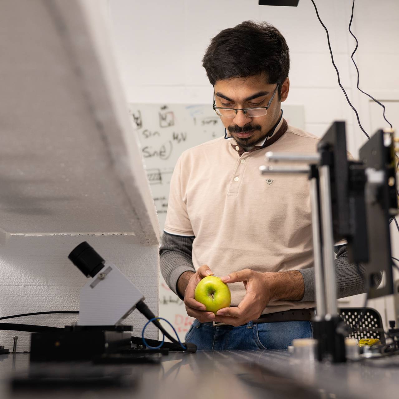 Subhajit Karmakar attaches a label to an apple