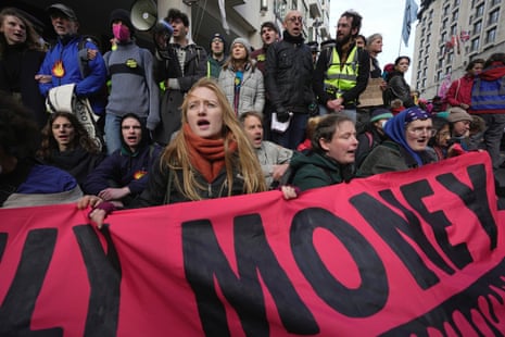 Environmental activist Greta Thunberg and other protesters shout slogan during the Oily Money Out protest outside the Intercontinental Hotel, in London, Tuesday, Oct. 17, 2023. (AP Photo/Kin Cheung)