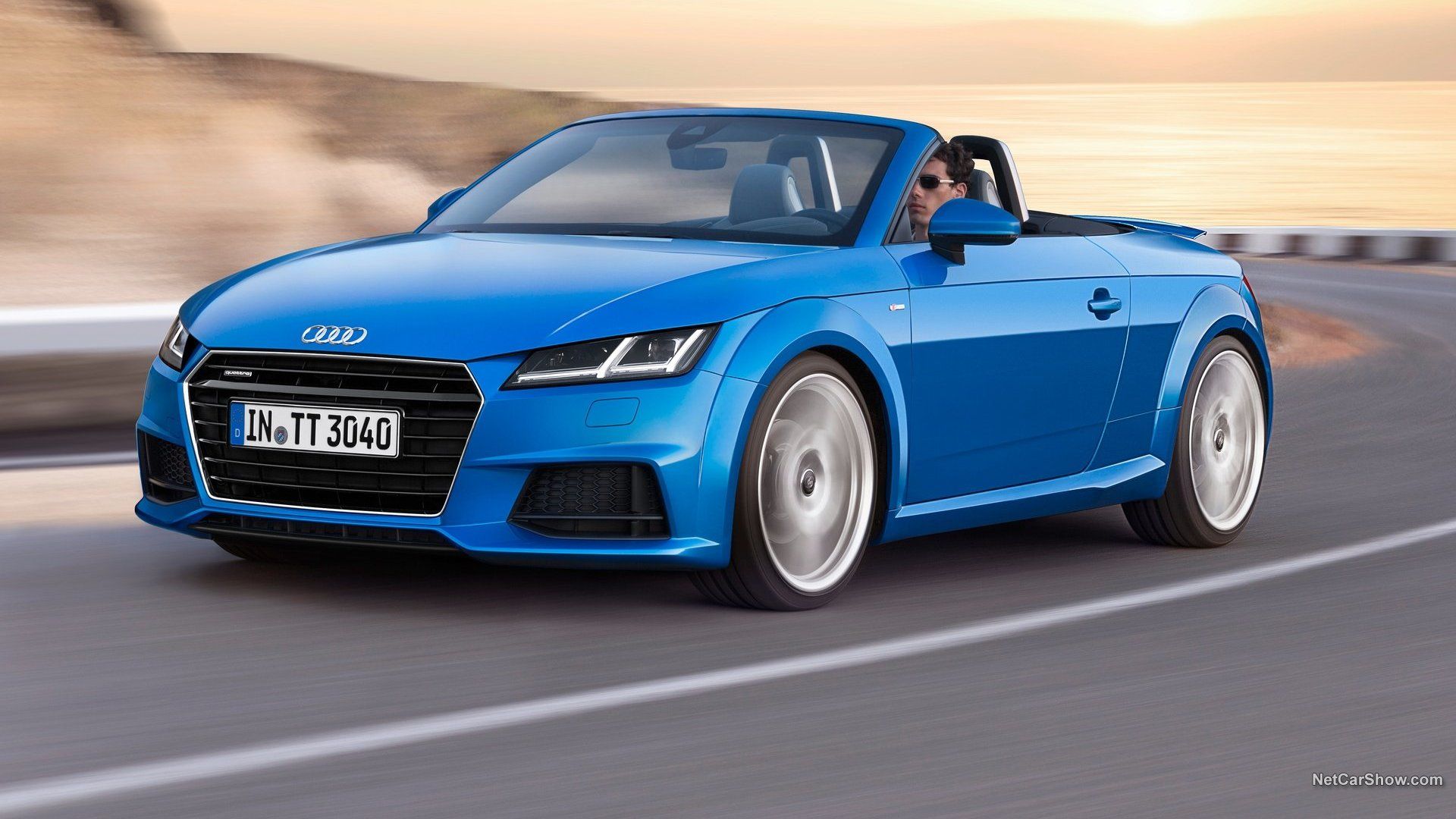 2015 blue Audi TT Roadster - front and left side view - convertible with roof down