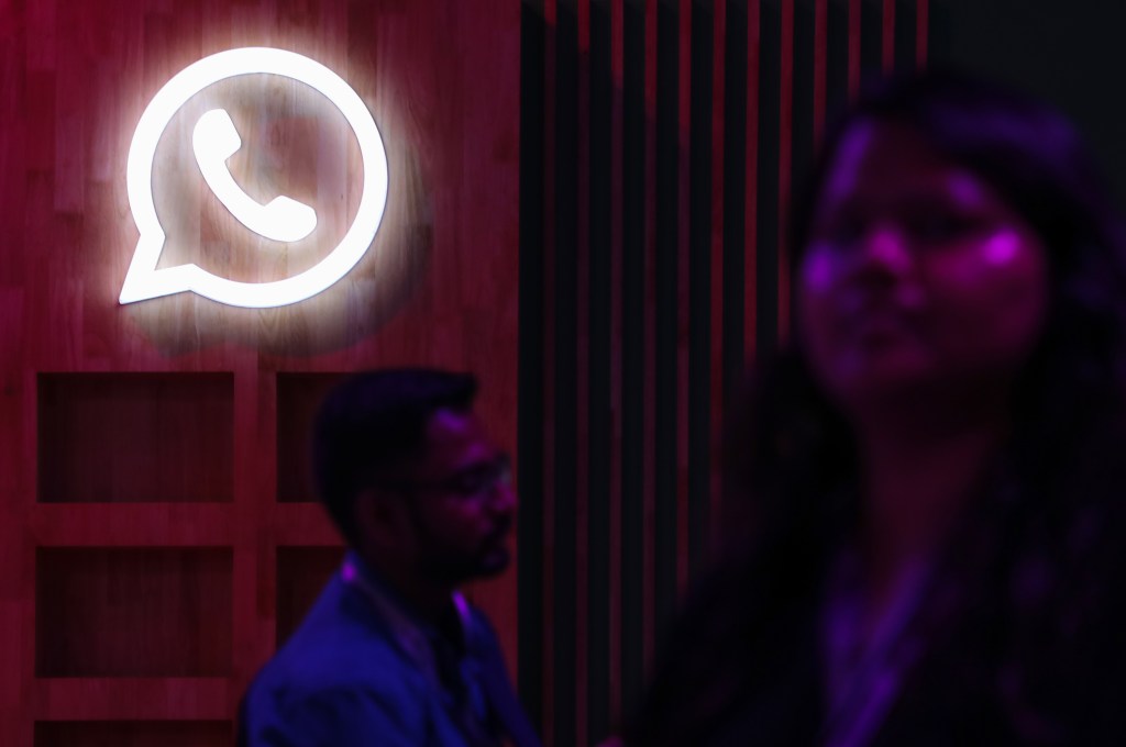 People walk past a logo of WhatsApp, during a Meta event in Mumbai, India, 20 September, 2023. (Photo by Niharika Kulkarni/NurPhoto via Getty Images)