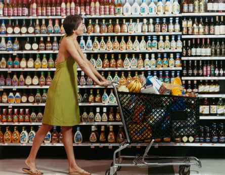 A woman in a supermarket with a shopping trolley in the early 1980s