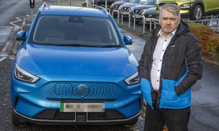 Brian Morrison stood in front of his blue MG vehicle