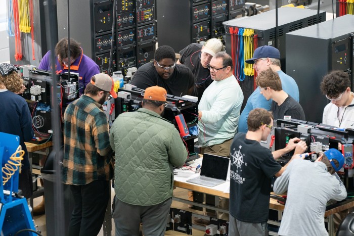 Instructor Stan Frost talks to students during a mechatronics learning programme at Midlands Technical College in Columbia, South Carolina