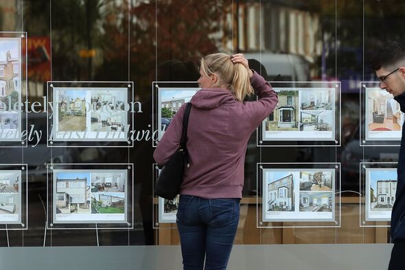 Person outside estate agent's window