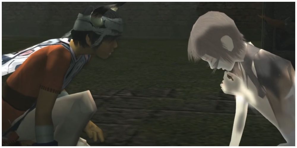 Ico kneeling in a courtyard in front of Yorda who is doubled over in pain