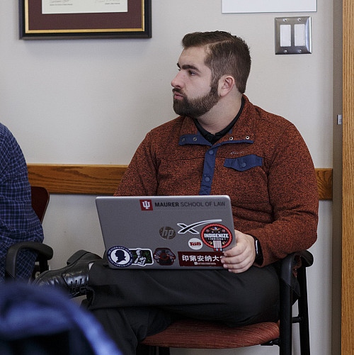 James Ramano sits with his laptop