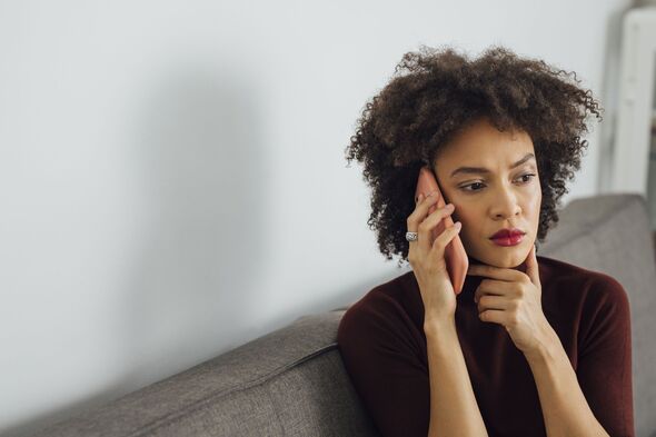 Woman looking worried on the phone 