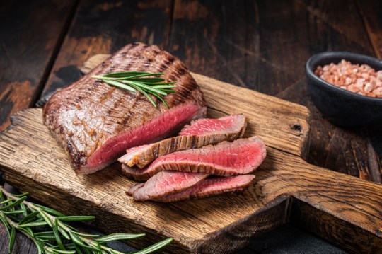 Barbecue dry aged wagyu Flank Steak on a cutting board. Wooden background as a fatty acid in red meat and dairy could help destroy cancer cells