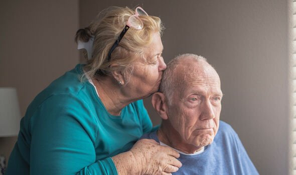 Woman kissing husband