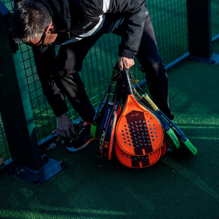 A padel player holding his racquet