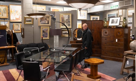 Browsing the mix of antique and modern lots for sale in the auction room.