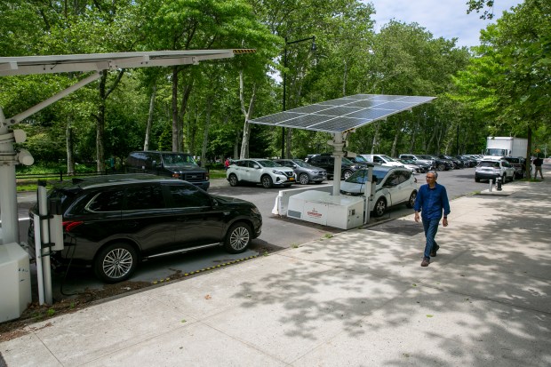 A solar-powered electric vehicle charging station is visible in the Brooklyn borough of New York City on Tuesday, May 24, 2022. (AP Photo/Ted Shaffrey)