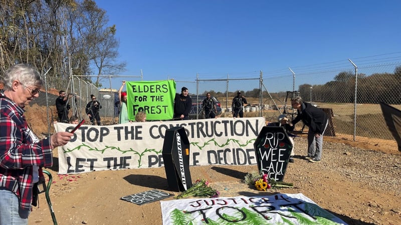 About two dozen protesters sat outside the future site of the Public Safety Training Center on...