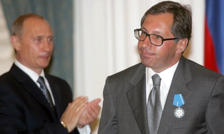 Vladimir Putin applauds Petr Aven after awarding him with the Order of Merit to the Fatherland during a ceremony at the Kremlin in July 2005.