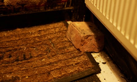 A brick on the floor under a radiator