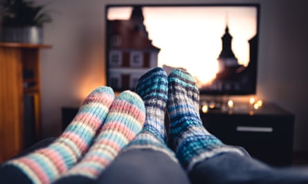 Couple wearing woollen socks watch TV