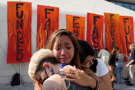 Mitzi Jonelle Tan, of the Philippines, embraces Adriana Calderon Hernandez, right, and Line Niedeggen, left, after protesting at Cop28.