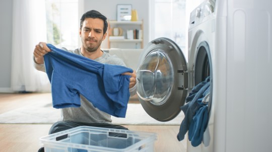 Man loads washing machine