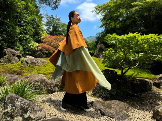 A very crisp and bright image of a woman in a garden.