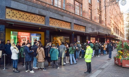 Customers queue outside the Harrods department store in Knightsbridge for the Boxing Day sale.