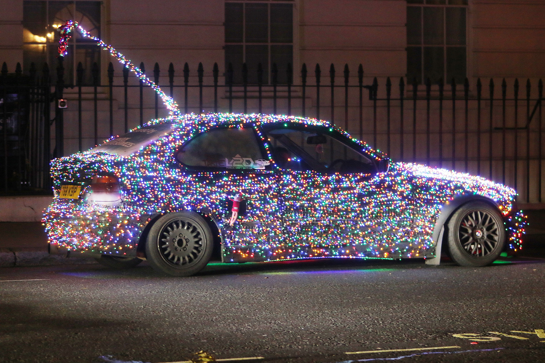 A covered in Christmas lights cruised the streets of London’s West End