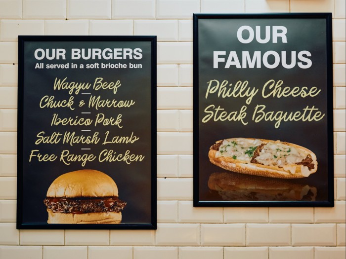 Posters on the wall of Porterford Butchers advertising its Philly cheesesteak baguette and burgers