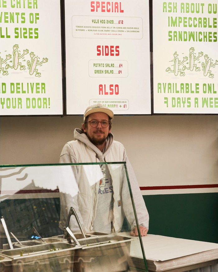 Greg Boyce, one of the three founders of Dom’s Subs, behind the shop’s counter